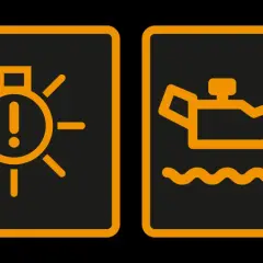 Voyant voiture : une ampoule avec un point d'exclamation et une burette d'huile. Ces symboles indiquent un problème.